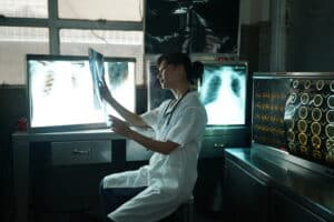 Doctor looking at x-ray image. Female medical doctor looking at x-rays in a hospital. Healthcare surgery diagnosis concept